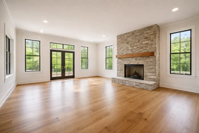 Before: Great room with a stone fireplace